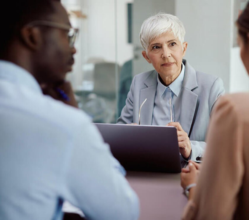 person organizing tax documents and calculator before year-end tax filing