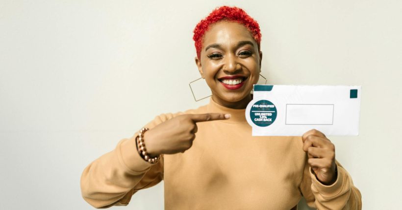 a woman holding an envelope