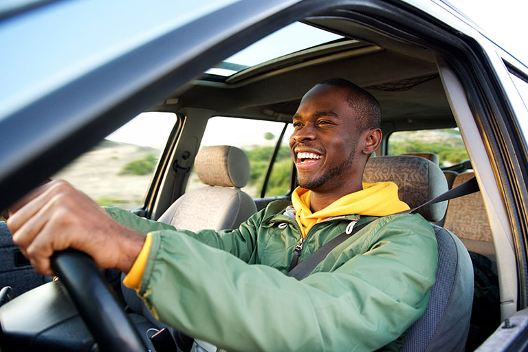 Man get auto loan and is driving away happy.