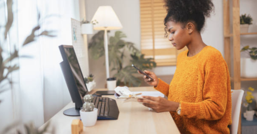 Woman using computer to aid in money management.
