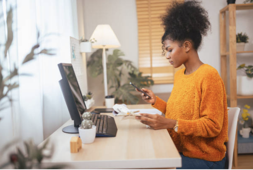 Woman using computer to aid in money management.