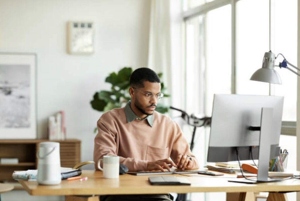 Man in home office managing finances.
