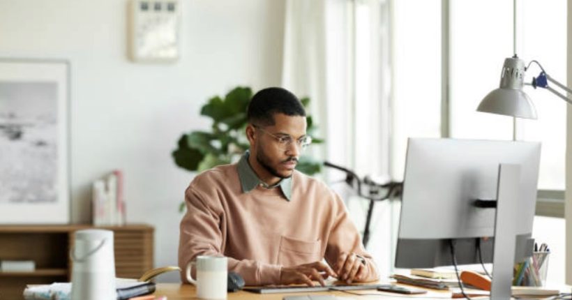 Man in home office managing finances.