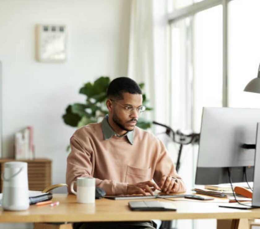Man in home office managing finances.