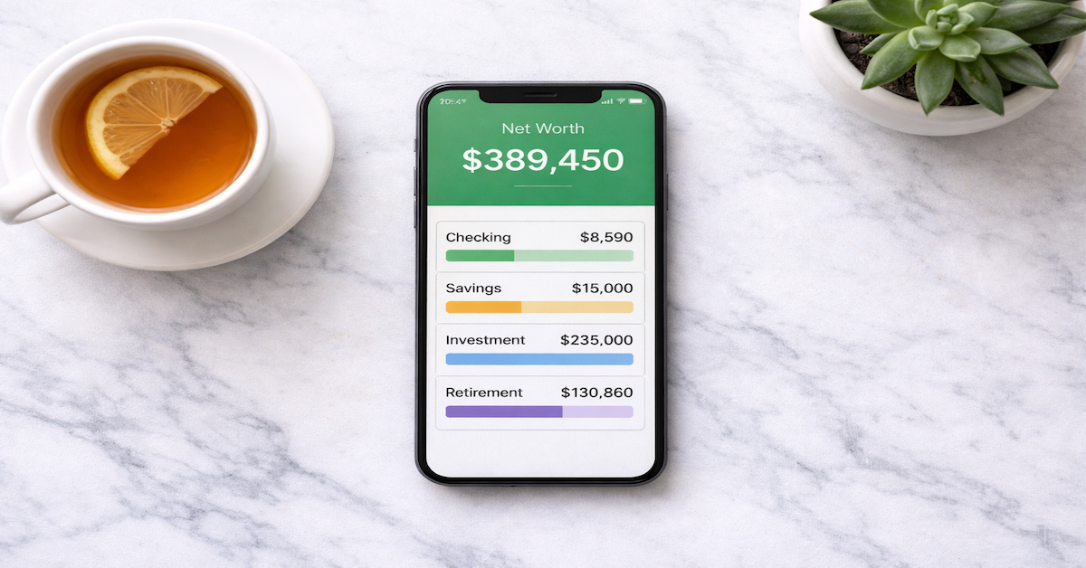 Smartphone on a marble surface displaying a net worth dashboard with multiple connected account balance tiles