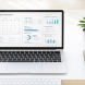 Clean modern workspace with laptop displaying a productivity dashboard, representing AI tool setup for small business owners