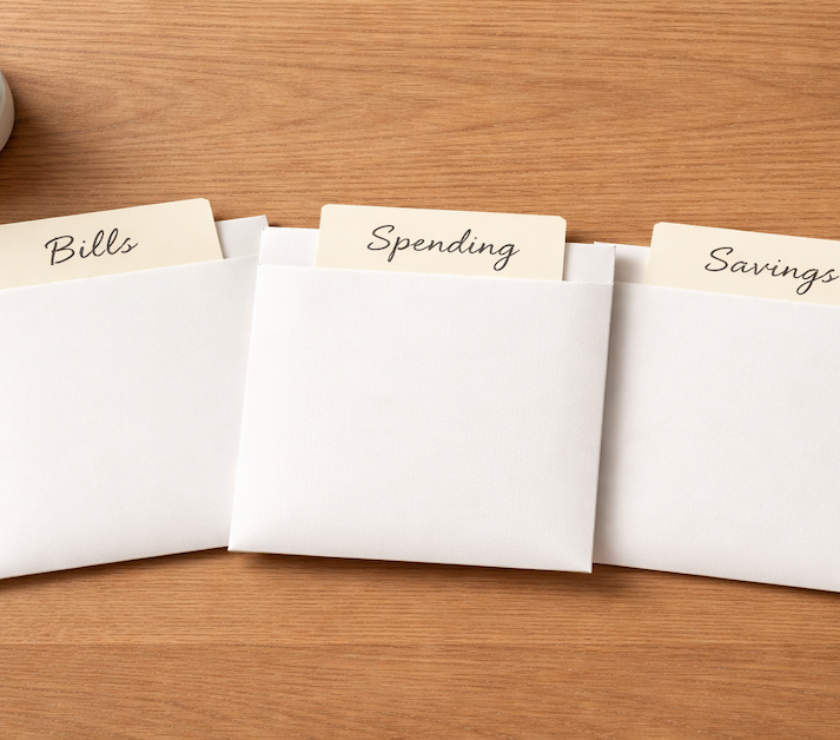 Three labeled envelopes representing a multi-account budget structure system for organizing cash flow