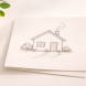 A paper house sketch beside a small green plant on a clean surface, representing the financial planning priorities of the family stage — income protection, childcare costs, and building a stable household financial system