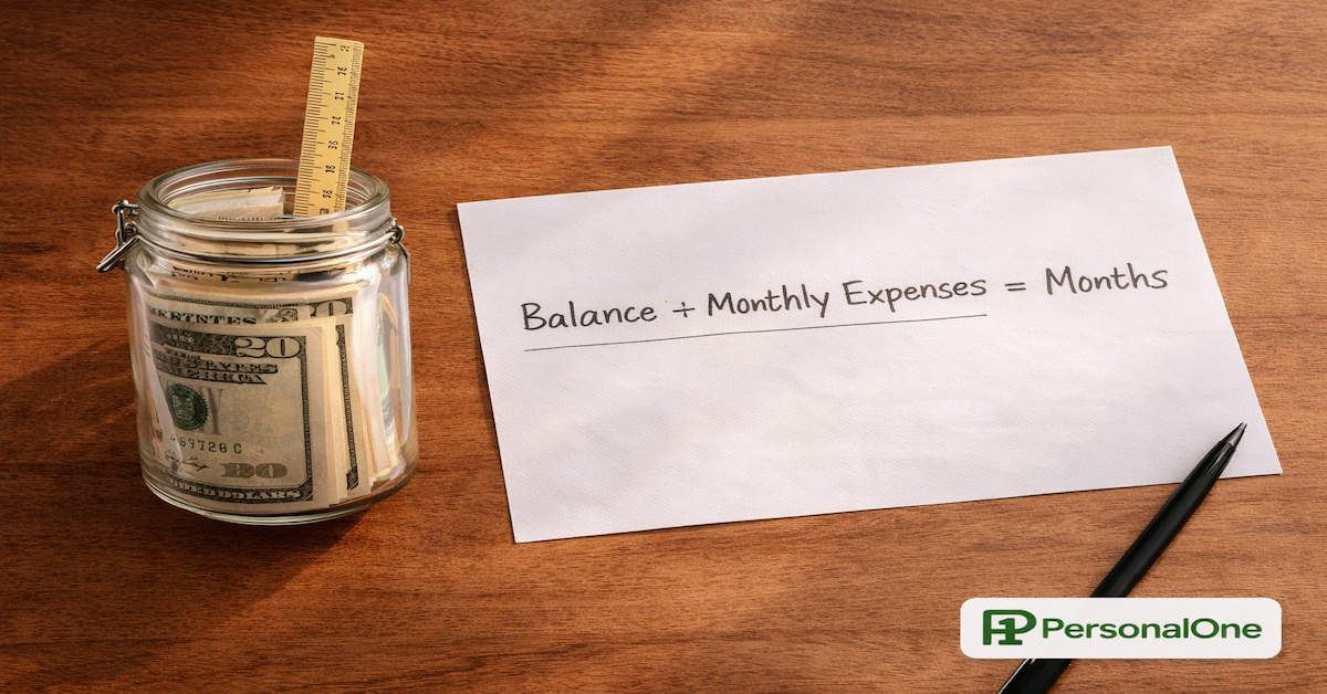 Glass savings jar with a ruler measuring the bill height beside a runway calculation on white paper on warm wood — PersonalOne