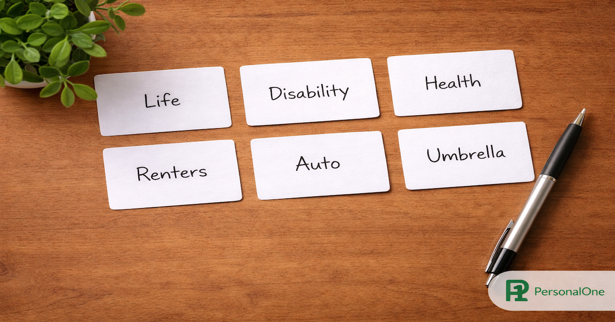 Six labeled insurance coverage cards reading Life, Disability, Health, Renters, Auto, and Umbrella arranged on a warm wood surface — PersonalOne