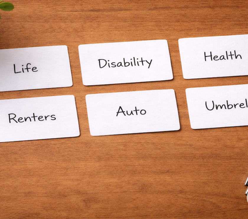 Six labeled insurance coverage cards reading Life, Disability, Health, Renters, Auto, and Umbrella arranged on a warm wood surface — PersonalOne