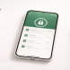 Smartphone on a white desk showing a secure banking dashboard with a small green plant beside it