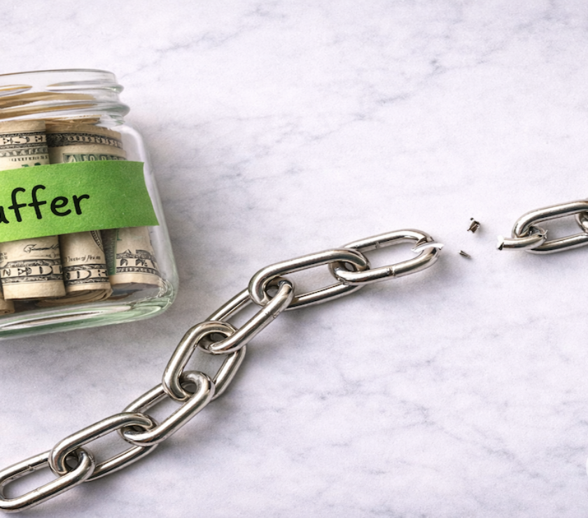Broken chain link beside a glass jar labeled Buffer filled with rolled bills on white marble — PersonalOne