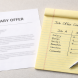 Salary offer letter beside a handwritten comparison of total compensation components, representing the negotiation of benefits beyond base pay