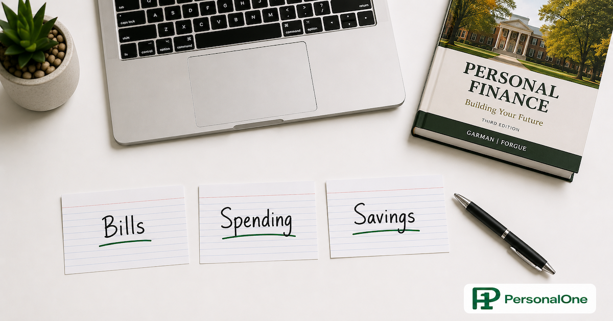 Three index cards labeled Bills, Spending, and Savings arranged on a student desk beside a pen and laptop — PersonalOne